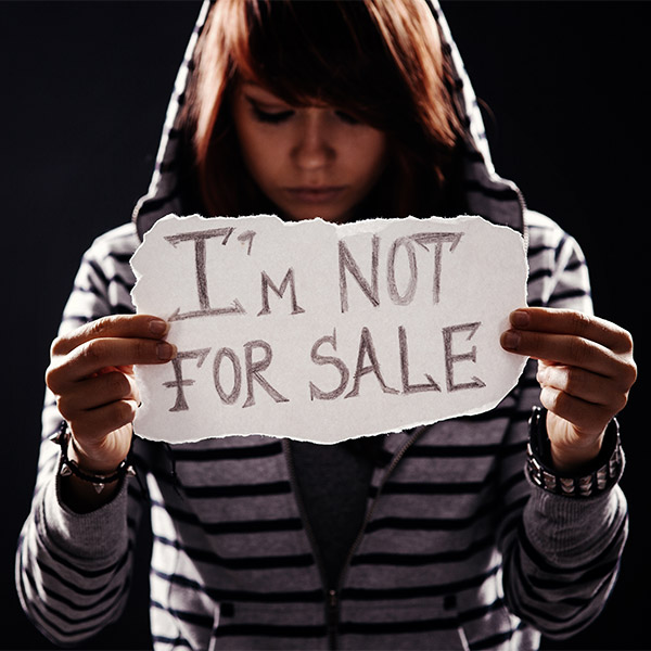 teen holding a sign that says I'm Not For Sale